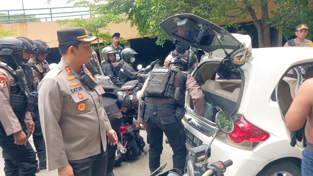 Wakapolresta Solo, AKBP Catur Cahyono bersama petugas melakukan pemeriksaan barang bawaan supoter PSS Sleman yang kedapatan membawa miras. (Foto: dok. Humas Polresta Solo)