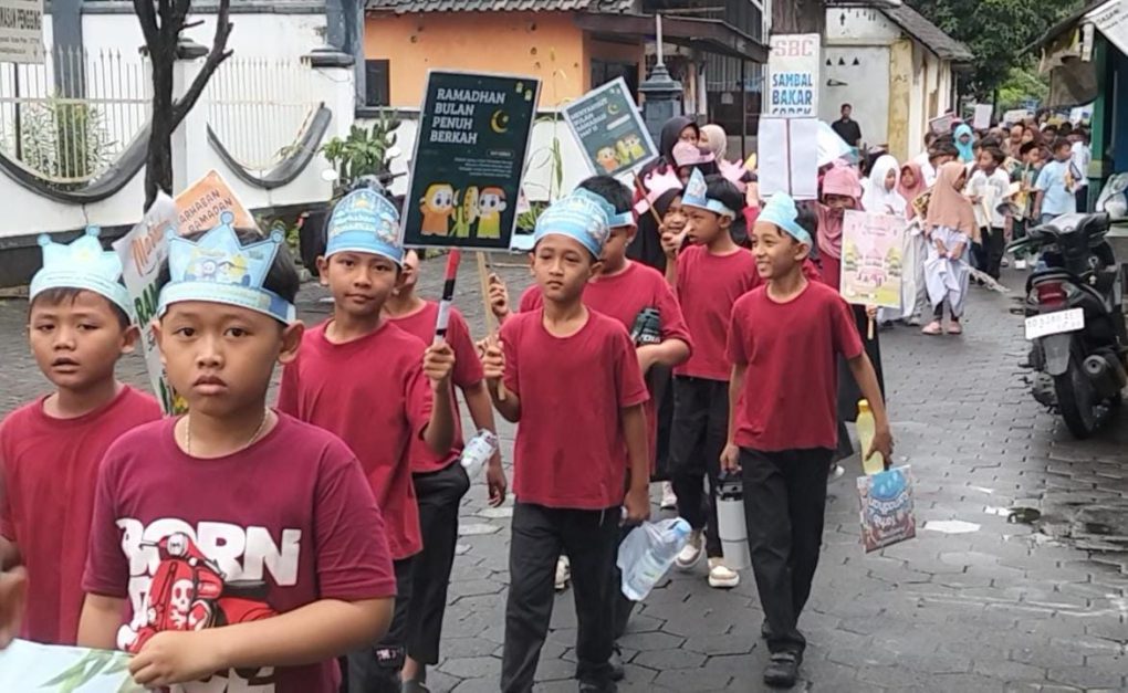 Siswa SD Muhammadiyah Program Khusus Banyudono membawa poster ajakan berpuasa saat mengikuti kirab sambut bulan suci Ramadan di Kecamatan Banyudono, Kabupaten Boyolali, Jawa Tengah, Senin 16 Februari 2026 pagi. (Foto: Agatha Janendra)